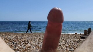 Woman walks passed erection on the beach