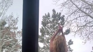 Heidi Klum on snowy deck in a g-string