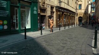 Cute blonde walks naked through central Prague