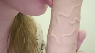 Young girl sucking dildo