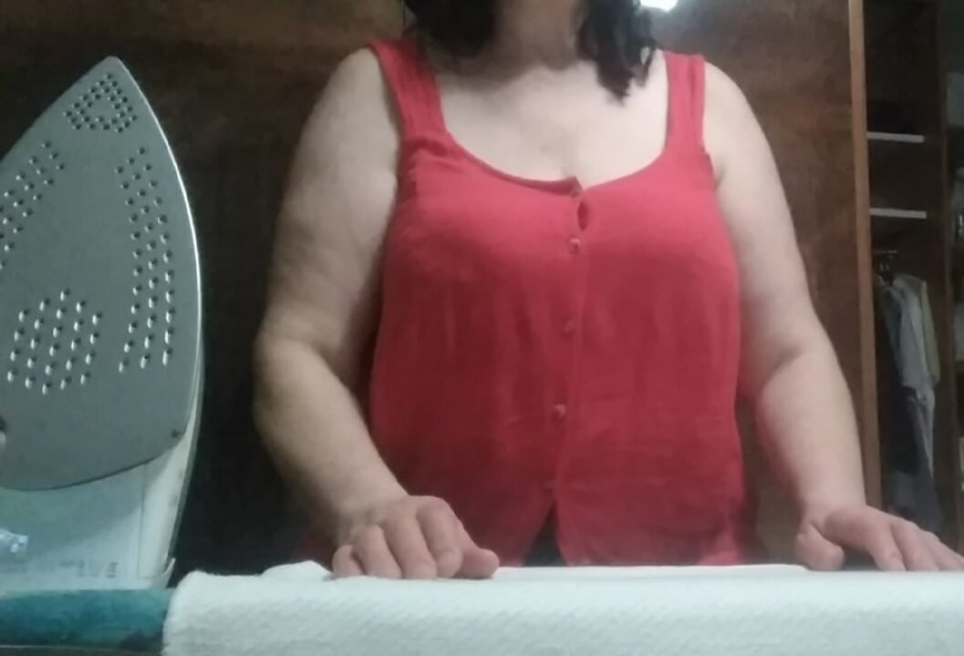 Stepmom, 57 years old, with Big Natural Tits, irons clothes and has a secret video call with her Stepson.